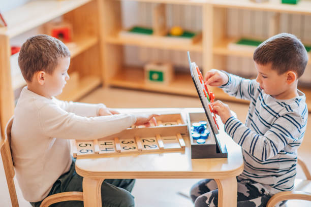istock Two boys playing together in preschool classroom 1195736115