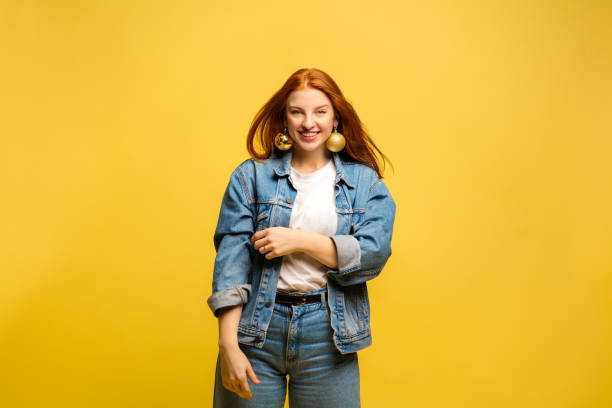 istock Caucasian woman's portrait isolated on yellow studio background 1195736746