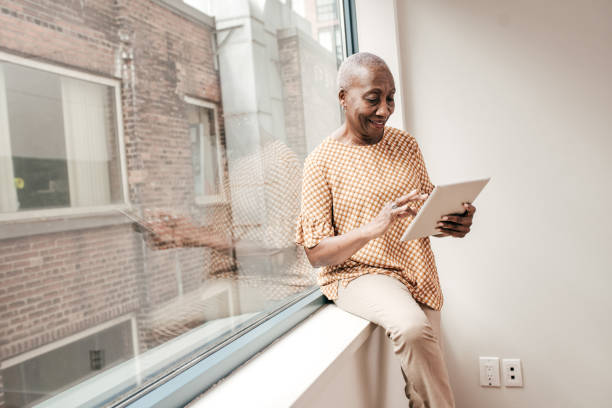 istock Senior woman with digital tablet 1195737104