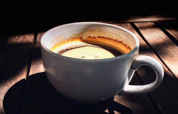 istock Black coffee in white cup on wooden table background. 1195738053
