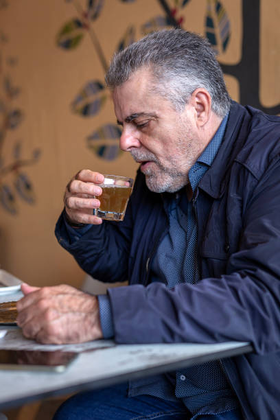istock Senior man with a beard walking in the city 1195738923