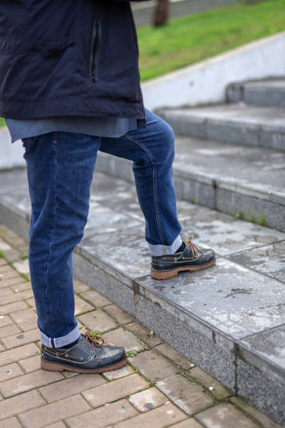 istock Senior man with a beard walking in the city 1195738926
