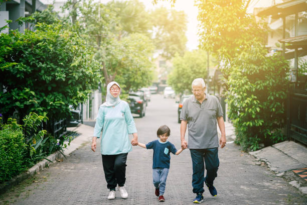 Lovely Senior Couple Walking with Grandson Sports Activities with Family happy malay couple stock pictures, royalty-free photos & images