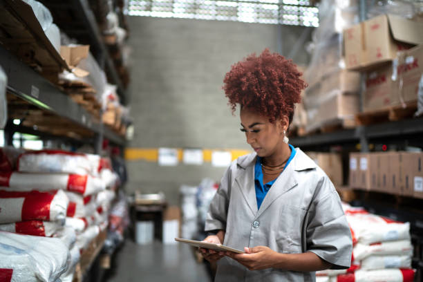 istock Technician using digital tablet while working in the production line of a factory checking products 1195741045
