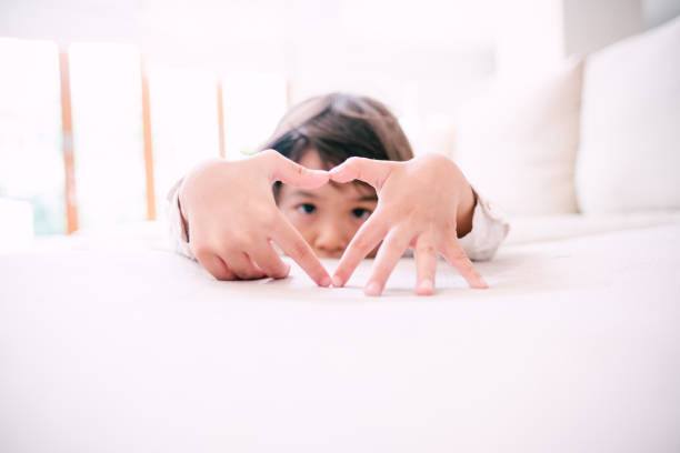 istock Lovely Little Kid Doing Love Sign 1195742409