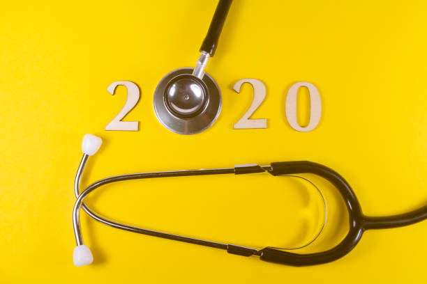 istock 2020 in wooden figures and stethoscope 1195742637