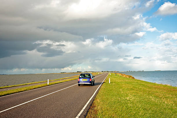 Driving on the dyke to Marken in Netherlands stock photo