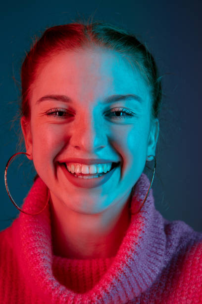 istock Caucasian woman's portrait isolated on gradient studio background in neon light 1195744907