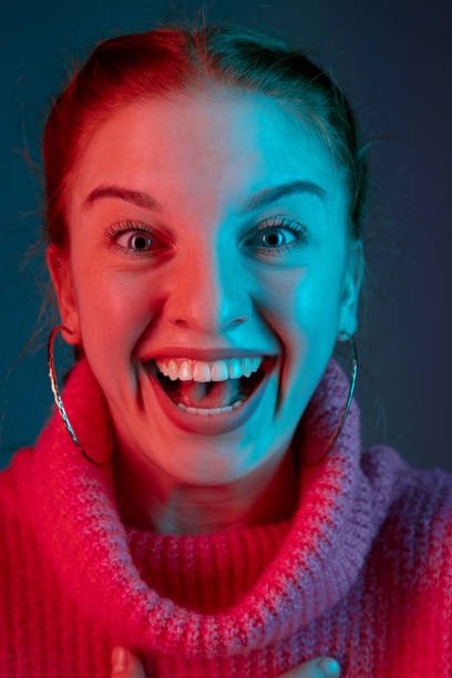 istock Caucasian woman's portrait isolated on gradient studio background in neon light 1195744919
