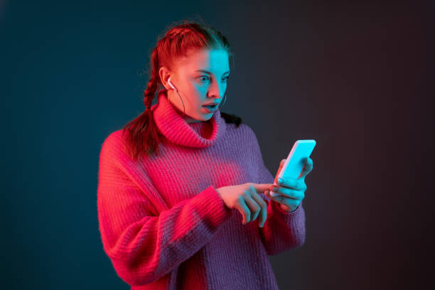 istock Caucasian woman's portrait isolated on gradient studio background in neon light 1195744927