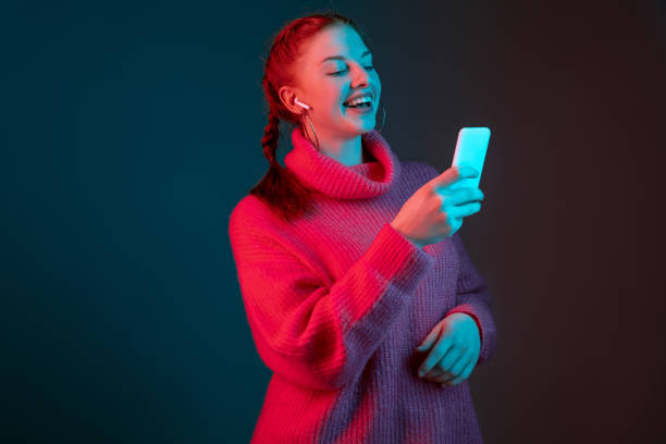 istock Caucasian woman's portrait isolated on gradient studio background in neon light 1195744932