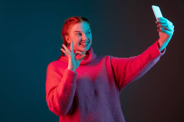 istock Caucasian woman's portrait isolated on gradient studio background in neon light 1195744937