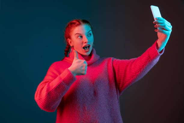istock Caucasian woman's portrait isolated on gradient studio background in neon light 1195744952
