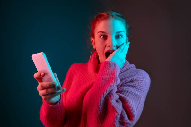 istock Caucasian woman's portrait isolated on gradient studio background in neon light 1195744955