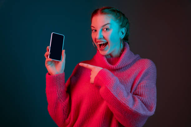 istock Caucasian woman's portrait isolated on gradient studio background in neon light 1195744956