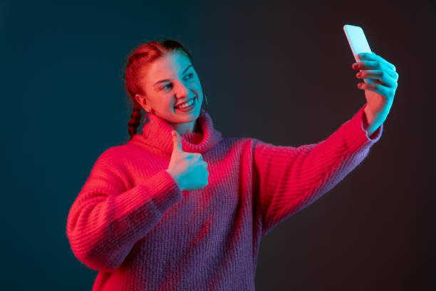 istock Caucasian woman's portrait isolated on gradient studio background in neon light 1195744963