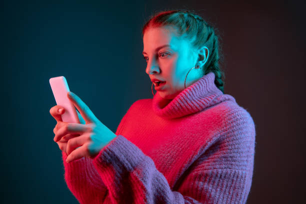 istock Caucasian woman's portrait isolated on gradient studio background in neon light 1195744966