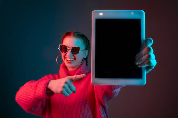 istock Caucasian woman's portrait isolated on gradient studio background in neon light 1195745498