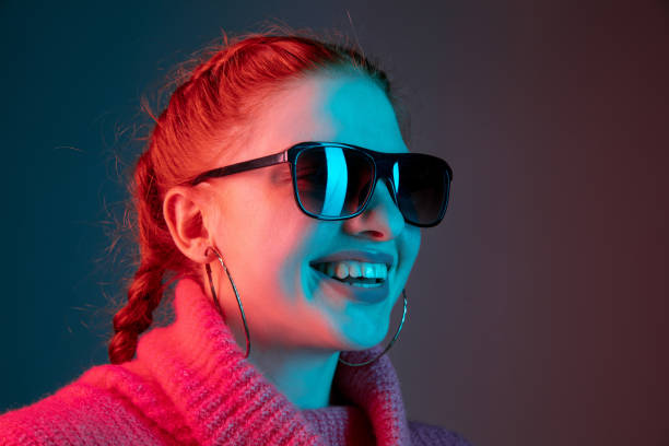istock Caucasian woman's portrait isolated on gradient studio background in neon light 1195745505