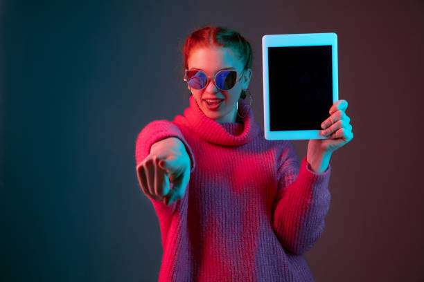 istock Caucasian woman's portrait isolated on gradient studio background in neon light 1195745518