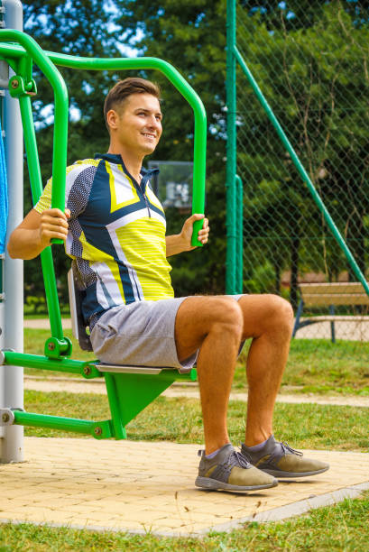 istock Man flexing arm in outdoor gym 1195746152