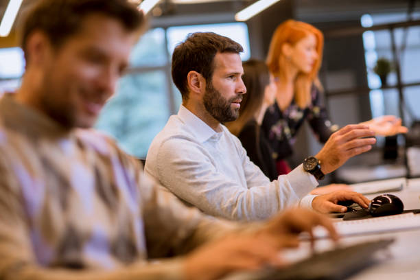 istock Group of young business people are working together with desktop computer 1195746220