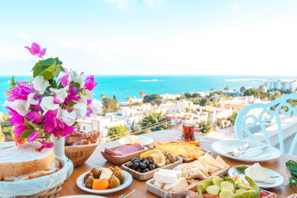 Breakfast on the beach at hotel or resort by the sea in summer season. Holiday and vacation breakfast image.	Traditional Turkish or Greek breakfast at bodrum town beach in Turkey or Greece Breakfast in restaurant at the beach. greek food stock pictures, royalty-free photos & images