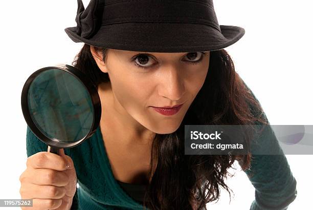 Young Woman With Magnifier Glass And Hat Looking To Camera Stock Photo - Download Image Now