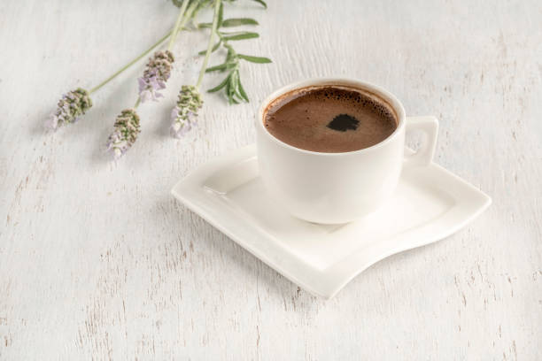 Turkish coffee on a table decorated with lavender flowers stock photo