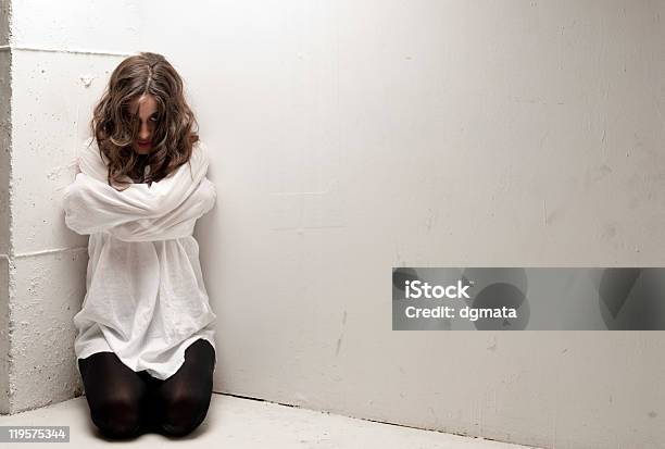 An Insane Woman With Straitjacket On Knees Looking At Camera Stock Photo - Download Image Now