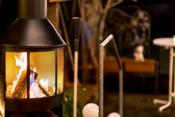 istock outdoor wood stove with burning open fire (nighttime) 1195757428