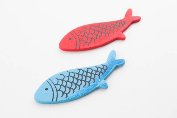 istock Colorful wooden fish on white background 1195757579