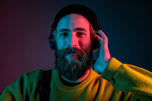 istock Caucasian man's portrait isolated on gradient studio background in neon light 1195758218