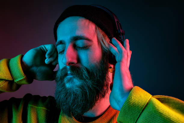 istock Caucasian man's portrait isolated on gradient studio background in neon light 1195758226