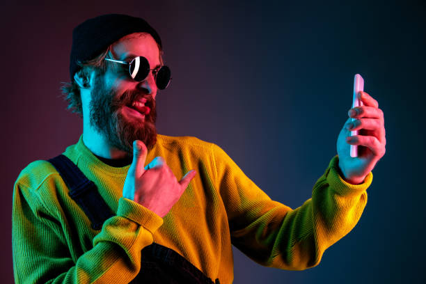 istock Caucasian man's portrait isolated on gradient studio background in neon light 1195758227