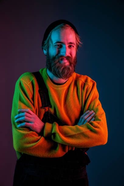 istock Caucasian man's portrait isolated on gradient studio background in neon light 1195758269