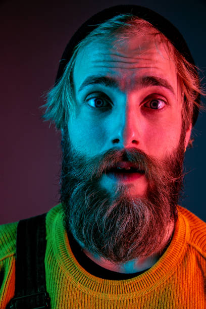 istock Caucasian man's portrait isolated on gradient studio background in neon light 1195758280