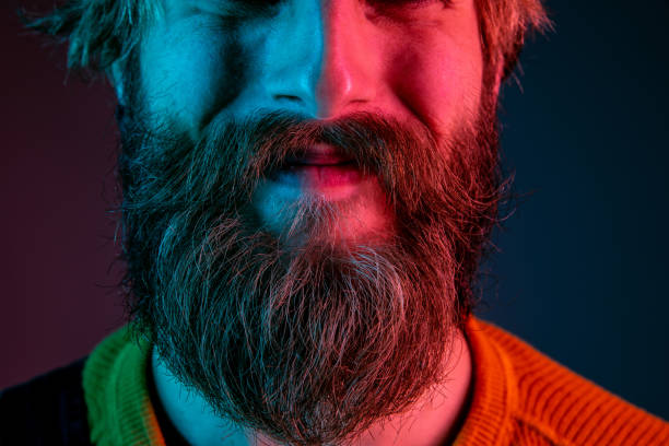istock Caucasian man's portrait isolated on gradient studio background in neon light 1195758281