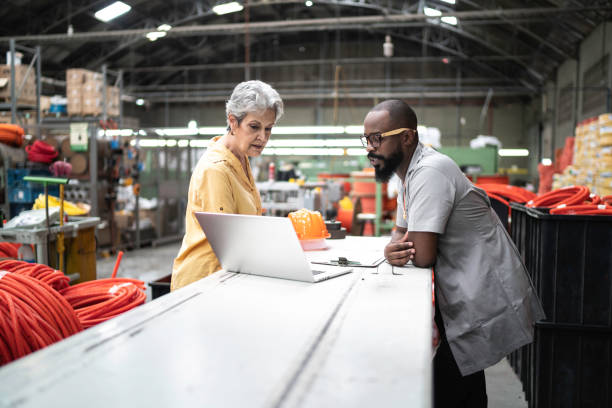 Colleagues working in industry and using laptop