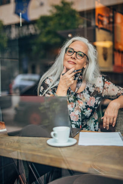 istock Old business lady sitting in cafe 1195760585