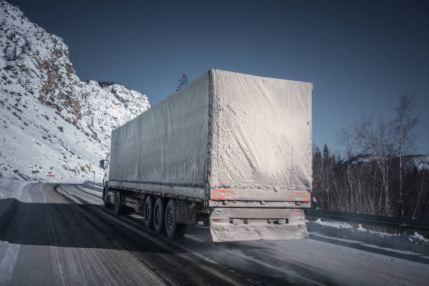 istock Freight truck on a winter road. 1195762498
