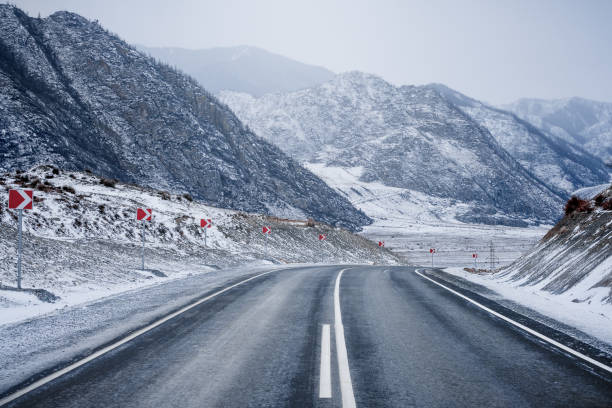 istock Winter road in mountains. Snow. 1195762512