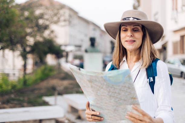 istock Beautiful traveller holding the map 1195764797