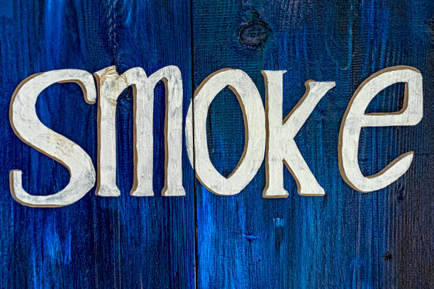 istock smoke sign on blue wood 1195765756