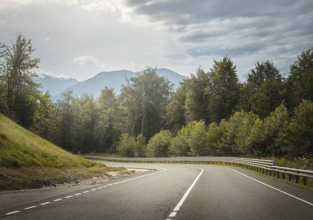 istock highland road through mountains. country highway. 1195767653