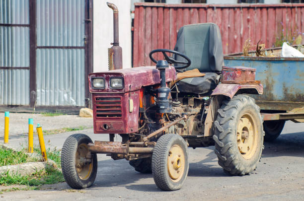 istock A small old mini tractor with a trailer stands on a rural street 1195769872