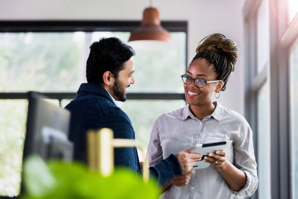istock Two employees smile happily to have finished their task 1195769907