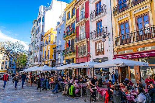 Valencia-Spain Dec. 21, 2019: Outdoors cafe and restaurants beside Mercado Central, a very frequented travel destination for tourist that visit Valencia city.