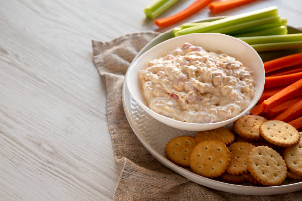 istock Homemade Pimento Cheese Dip with carrots, celery and crackers, side view. Copy space. 1195770211