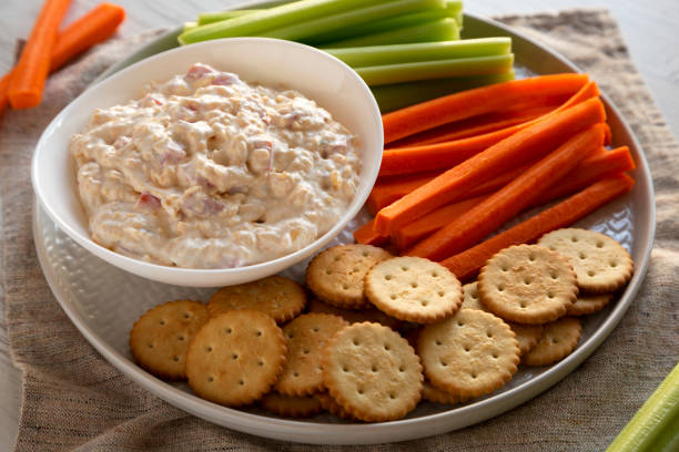 istock Homemade Pimento Cheese Dip with carrots, celery and crackers, low angle view. Close-up. 1195770240